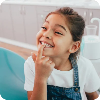 pediatric dental patient pointing at her teeth